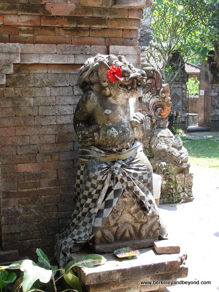 statue covered in black-and-white checked cloth to keep a balance between evil and good in Bali statue covered in black-and-white checked cloth to keep a balance between evil and good in Bali