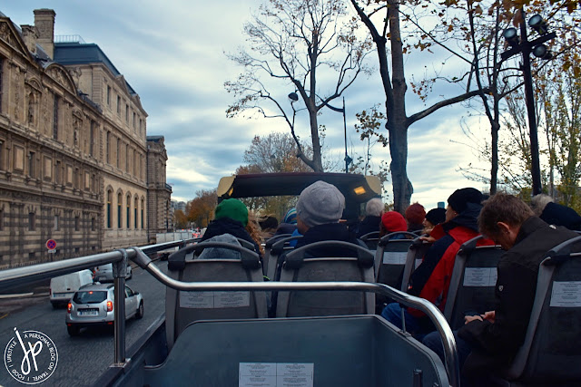 double decker bus, tourists, buildings