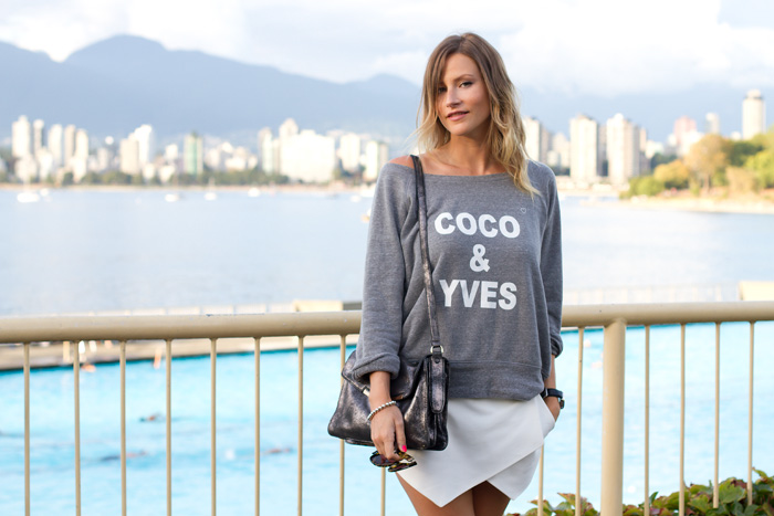 Vancouver Fashion Blogger, Alison Hutchinson, wearing a grey sweater from XO Bella, white Zara skort, off-white Converse All Star, BOtkier Valentina Bag, and Sass & Bide Sunglasses