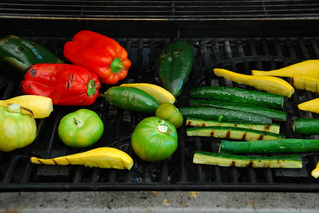 red peppers, poblano peppers, jalapeño peppers, tomatillos, yellow squash, and zucchini roasting on grill