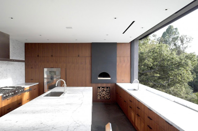 large kitchen with wood and stone touch, natural light from large glass