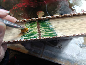 paint a pine tree on thrift store books