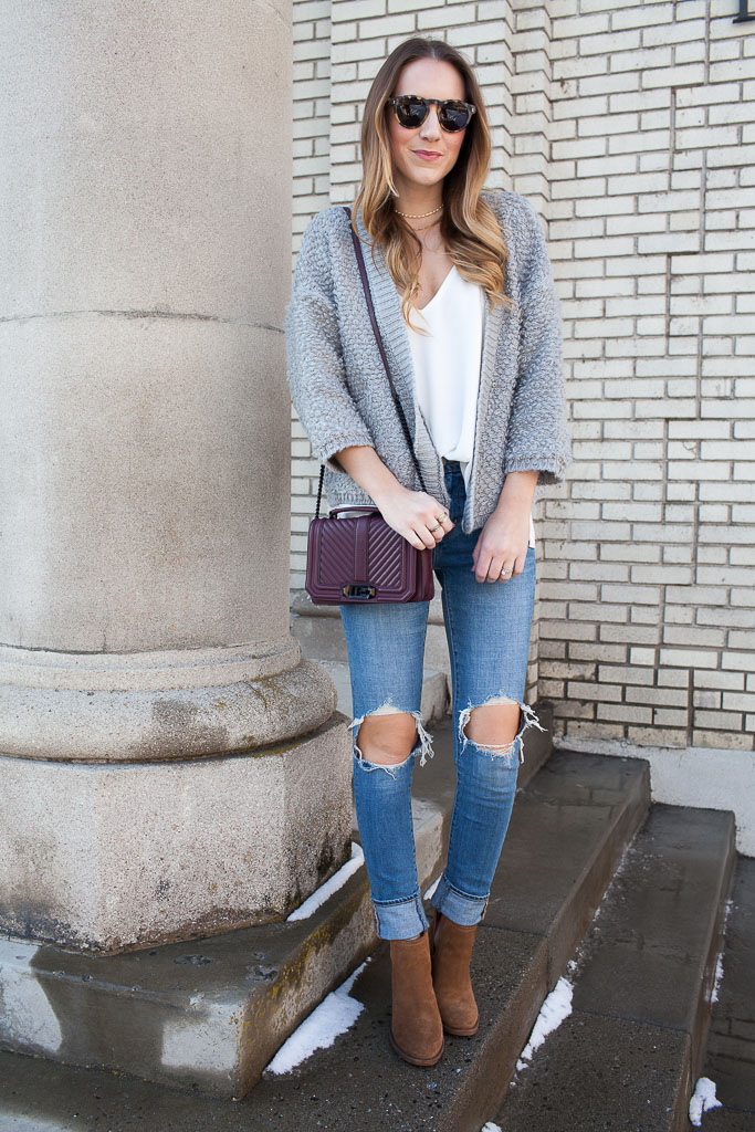 A fuzzy cardigan paired with distressed denim and cutout booties
