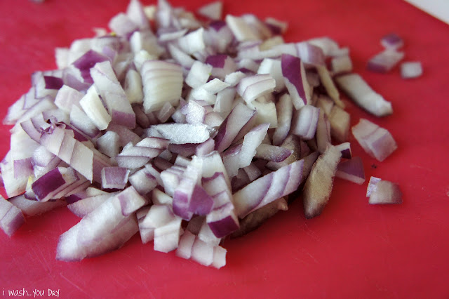 Chopped onions on a cutting board.