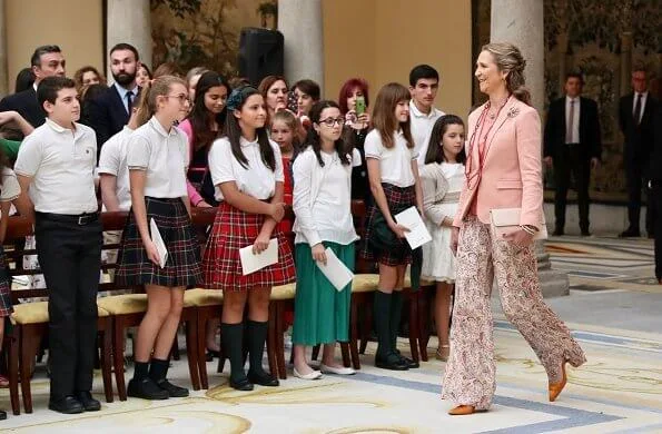 Infanta Elena of Spain wore Boss pumps and Mango pink jacket and Zara print trousers carried Mango clutch