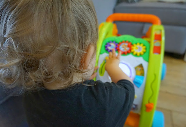 toddler boy playing with the little tikes light 'n' go walker