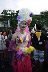 man dressed up in colorful women's clothing and wearing a large wig at 2011 Taiwan LGBT Pride Parade