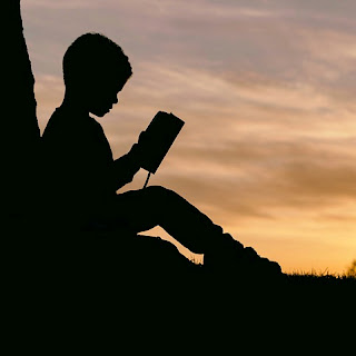 Autistic Boy reading Roald Dahl