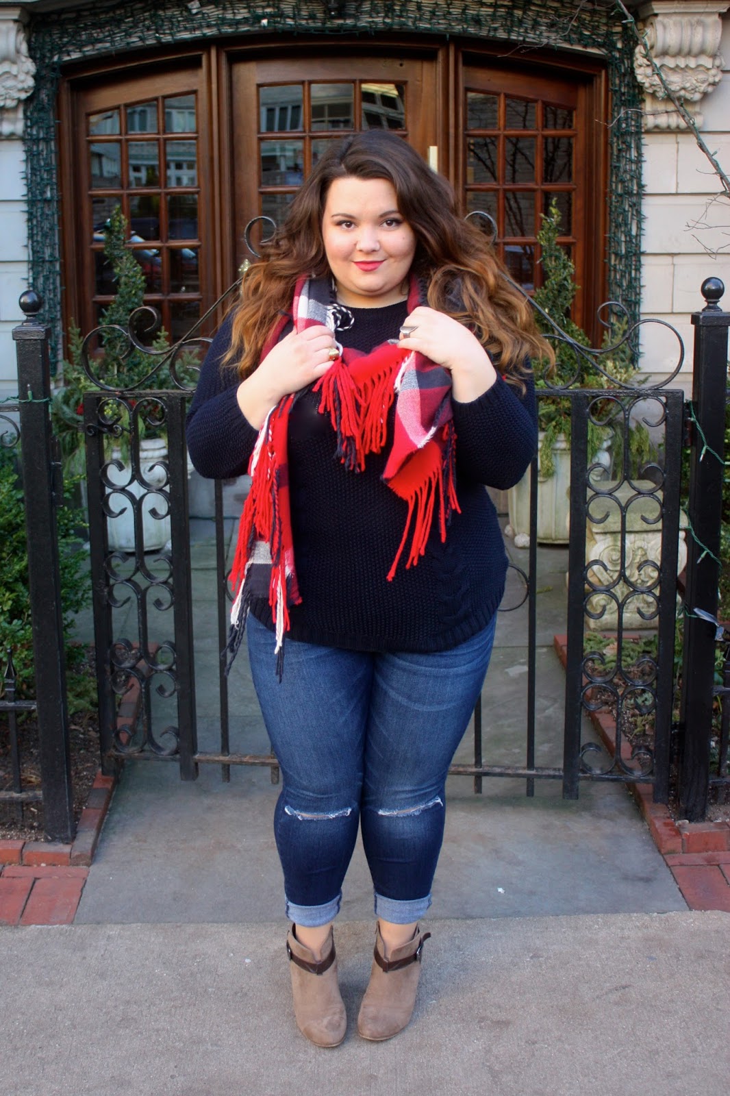 cable knit sweater, button down back sweater, red plaid scarf, fringe scarf, holiday style, natalie craig, natalie in the city, chicago, plus size fashion blogger, plus size, jeans with holes in the knees, taupe ankle boots with a brown strap, ankle booties, how to wear ankle boots, ps fashion ootd, blogger, fashion