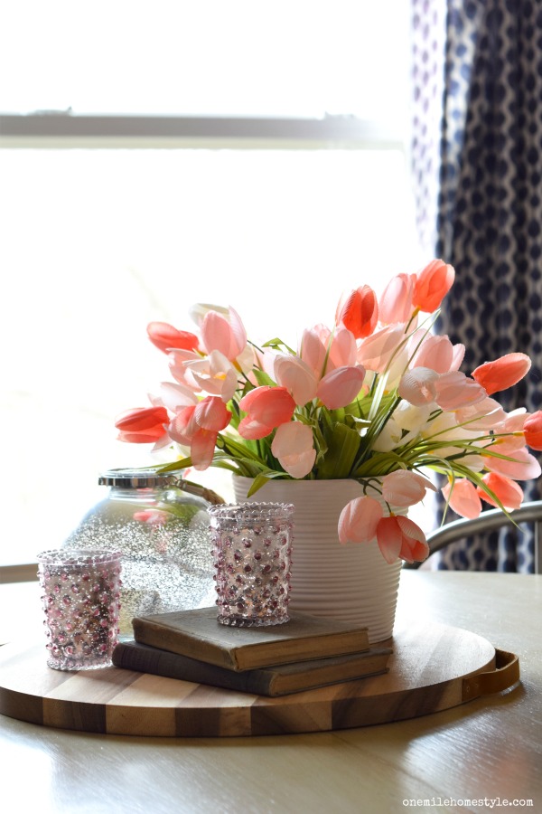 Pretty pink spring home decor tour, tulips and vintage books make a beautiful farmhouse style kitchen table centerpiece. 