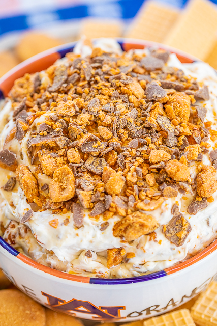 Butterfinger Dip - only 4 ingredients and ready in minutes!!! This stuff should come with a warning label - SO good!!! Cream cheese, cool whip, brown sugar and butterfinger candy bars. Serve with vanilla wafers, sugar cookies, fruit, graham crackers or pretzels. Can make a day in advance and refrigerate until ready to serve. Great for tailgating and holiday parties!! Everyone RAVES about this yummy dessert dip! #dessert #dip #partyfood #butterfingers Butterfinger Dip - only 4 ingredients and ready in minutes!!! This stuff should come with a warning label - SO good!!! Cream cheese, cool whip, brown sugar and butterfinger candy bars. Serve with vanilla wafers, sugar cookies, fruit, graham crackers or pretzels. Can make a day in advance and refrigerate until ready to serve. Great for tailgating and holiday parties!! Everyone RAVES about this yummy dessert dip! #dessert #dip #partyfood #butterfingers