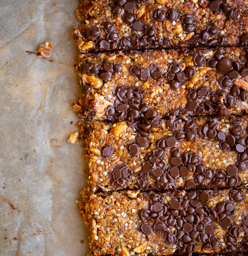 Chewy Hemp Nut Granola Bars with Chocolate lined up on parchment paper