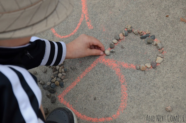 Tracing letters activity with chalk and rocks