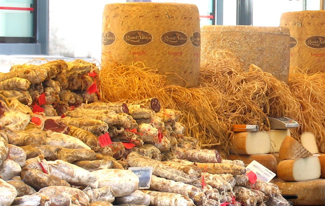Samples of cheese and sausages on sstall at Loches market