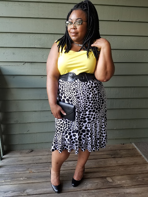 Kishina wearing curve flattering outfit, skirt, heels, dressy tank plus size dressy outfit, fluted skirt, dressy tank, cat-eye glasses