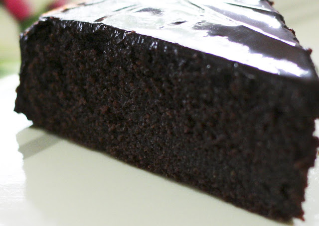 A slice of dense chocolate cake