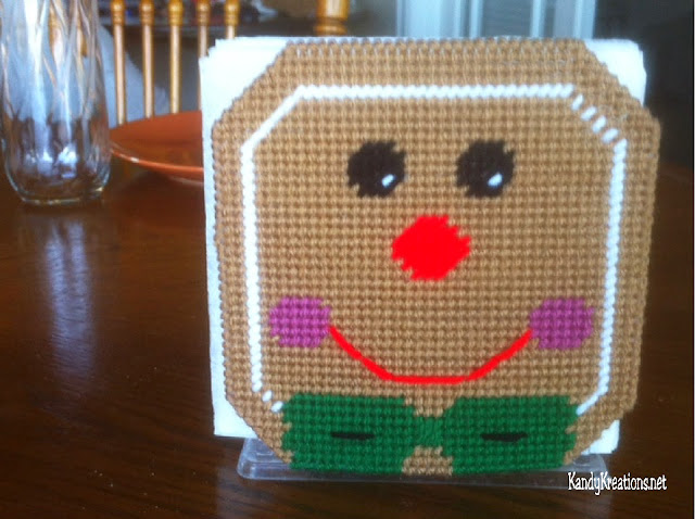 Decorate your kitchen or Christmas party with this free plastic canvas pattern for your Dollar Store napkin holder.  Easily add a bit of Gingerbread whimsy with this Gingerbread man pattern that slides over your holder and brightens up your home.