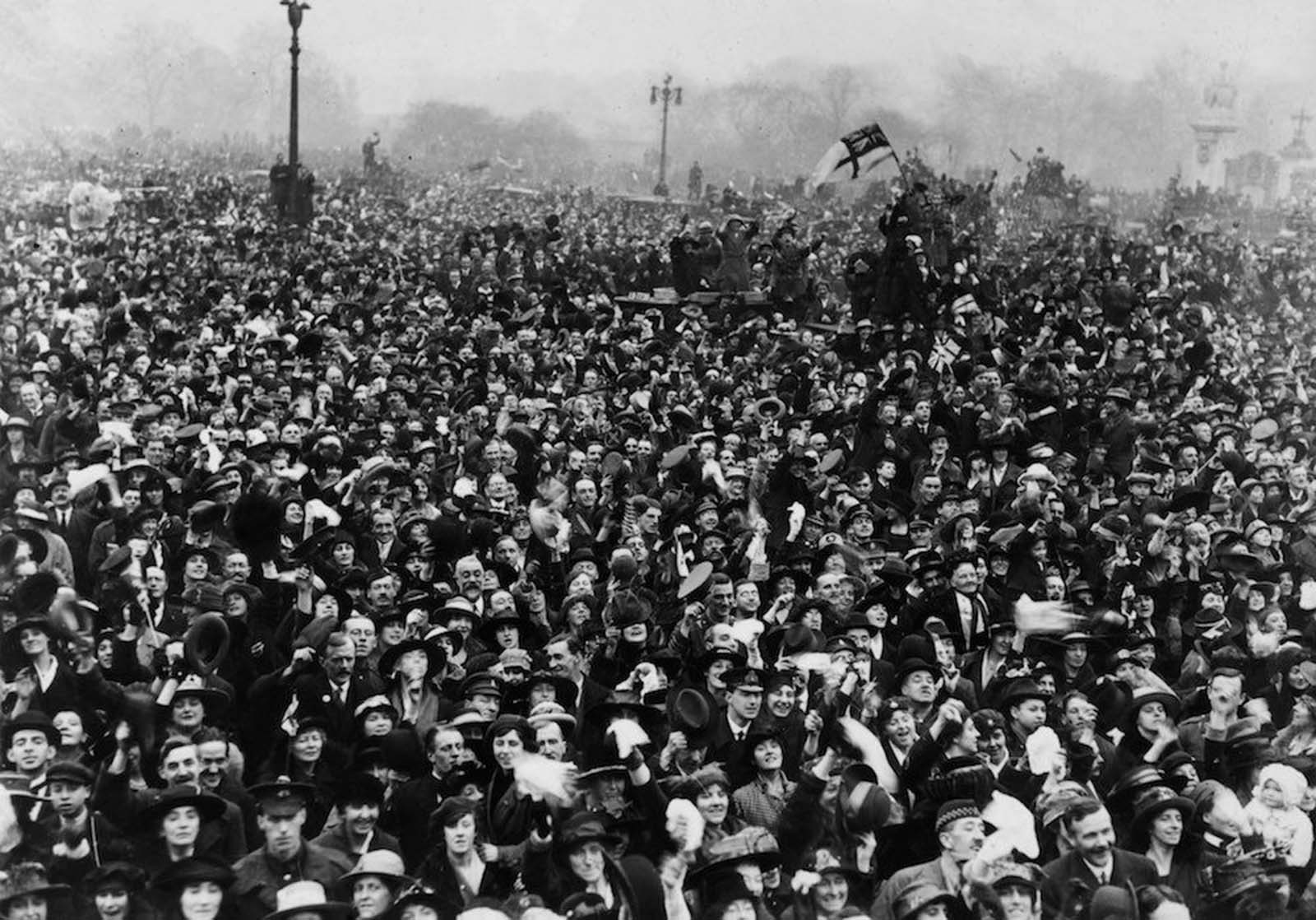 Jubilant crowds close to Buckingham Palace, London, celebrating Armistice Day.