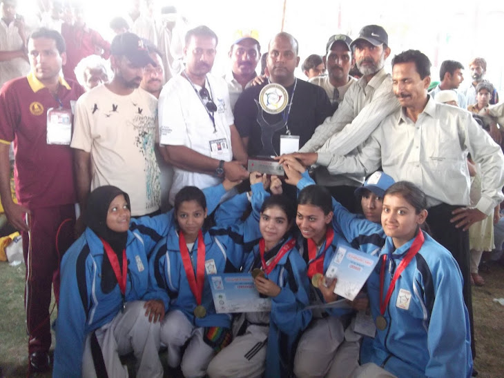 Coach Kamran Kureshi with female team rcving 1st position trophy in Sindh games 2011.