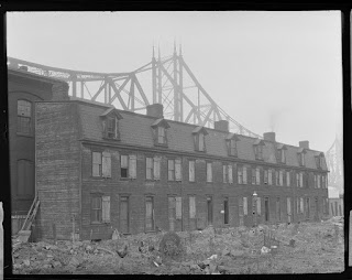 Chickens grazing in front of worker's row-houses at the Point, 1917, Pittsburgh