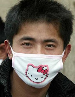 Asian guy wearing weird Hello Kitty face mask