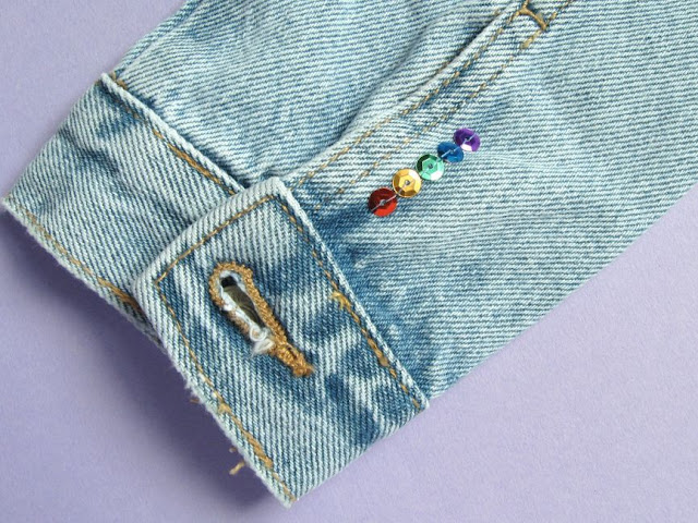 Rainbow sequins on the cuff of a denim jacket