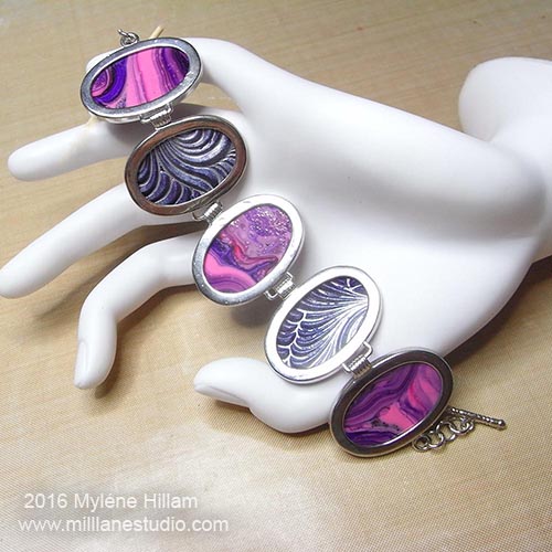 Silver bracelet with alternating oval disks of marbled purple and pink resin and silver and purple textured resin.