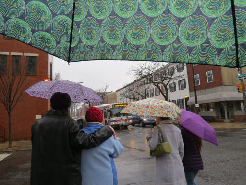 people walking with umbrellas