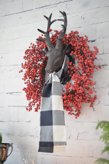 whitewashed brick wallpaper | reindeer head with berry wreath and plaid scarf | Ramblingrenovators.ca
