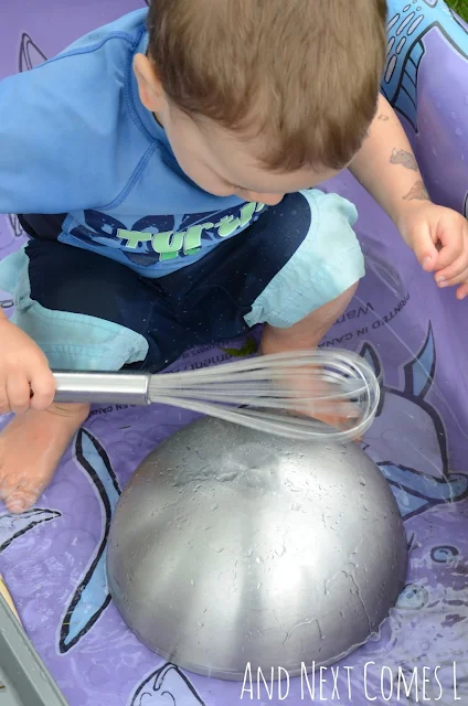 Kid enjoying a musical science pool experiment