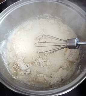 dairy free milk and gluten free flour simmering in a saucepan