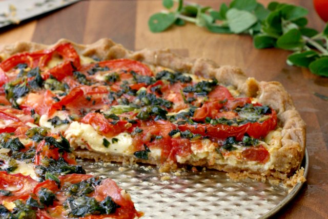 Summer Tomato Tart: A cheesy tomato tart with fresh herbs on buttery pastry. A thin layer of Dijon mustard spread under the tomatoes gives it a little bite.