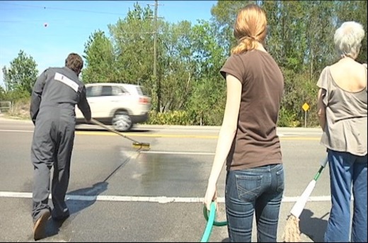 Ateos limpiando carretera con agua