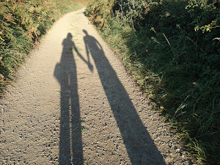 elongated shadow of couple holding hands