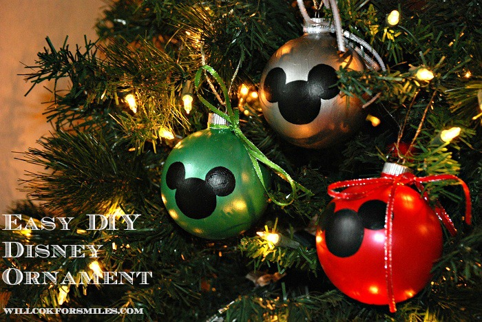 3 mickey ornaments on a Christmas tree 