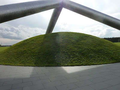 Tetra Mound at Moerenuma Koen (Moerenuma Park), Sapporo. There are three big metal columns that meet above a mound of grass