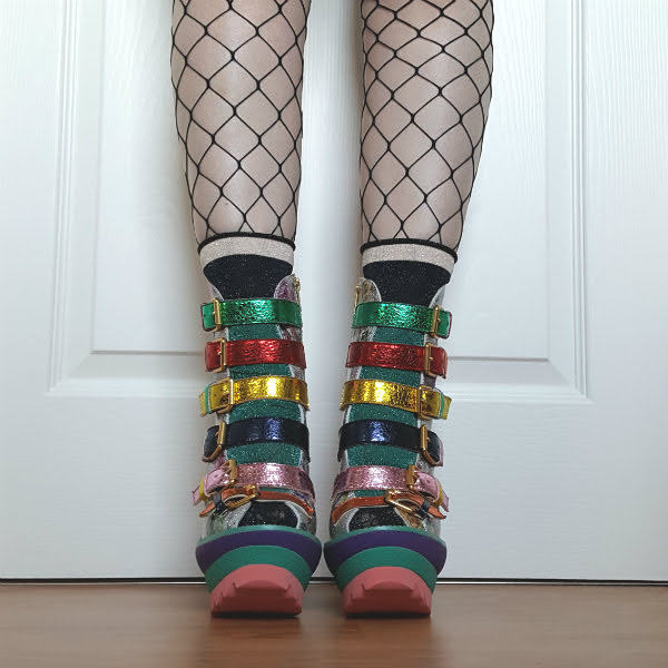 Irregular Choice Roarsum by Tomi Platts front feet facing forwards wearing metallic, multi coloured strap platform boots with sparkly socks and whale net tights
