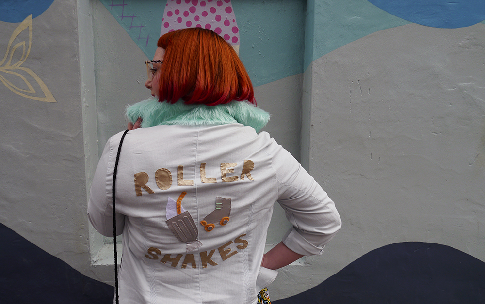 Roller Shakes where milkshakes meet roller skates Styled by Helen, Wardrobe Conversations, Scottish Blogger, Edinburgh Blogger, Dundee Blogger, red head, ginger bob, Spex Pistols glasses, leopard print glasses, customised denim jacket, mint fur collar, Monki prints, Monki tshirt, Monki x Lynnie Zulu, Lynnie Zulu for Monki, River Island white lace up shoes, Rockcakes brooch, Rock Cakes pin badges, personalised denim jacket, Lucky Dip pins, milkshake with sprinkles, Roller Shakes, Blog Birthday, Style Diner, Kate George Mural Edinburgh, wall art Edinburgh, Edinburgh South side, Lou Taylor, tropical earrings, skinny dip london milk bag, novelty bag, milk bag
