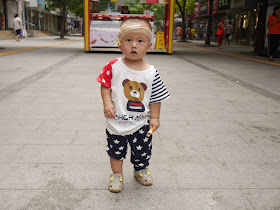 little boy wearing clothing with a red, white, and blue stars & stripes design