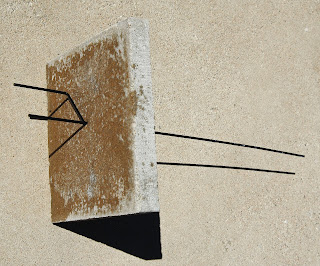 metal post placed through patio pavement square