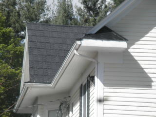 Black stamped shingle roof with one of Cortright's four designs