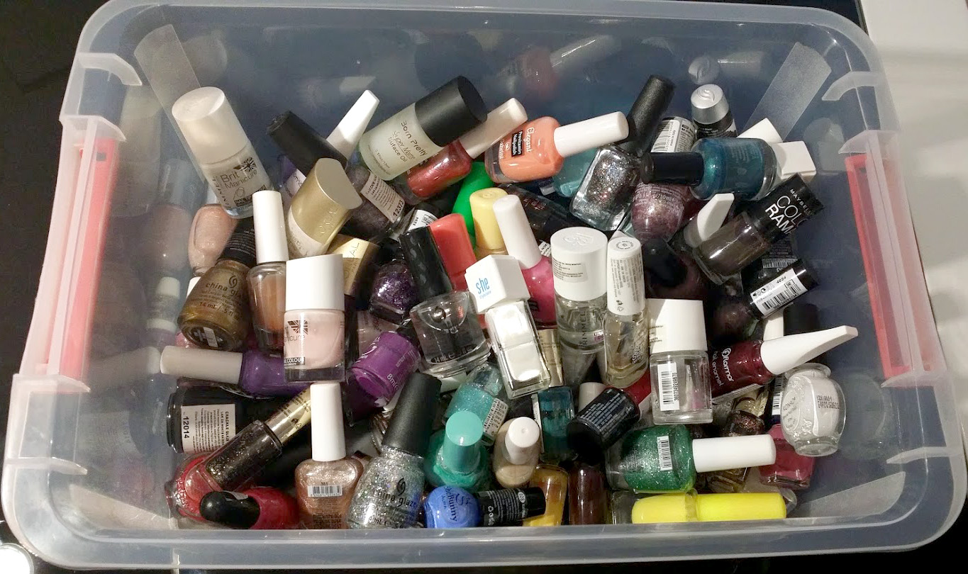 pile of nail polish clutter in a bin
