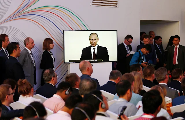 Image Attribute: Russian President Vladimir Putin is seen on a television screen as he speaks during a joint news statement after India-Russia Annual Summit in Benaulim, in the western state of Goa, India, October 15, 2016. REUTERS/Danish Siddiqui