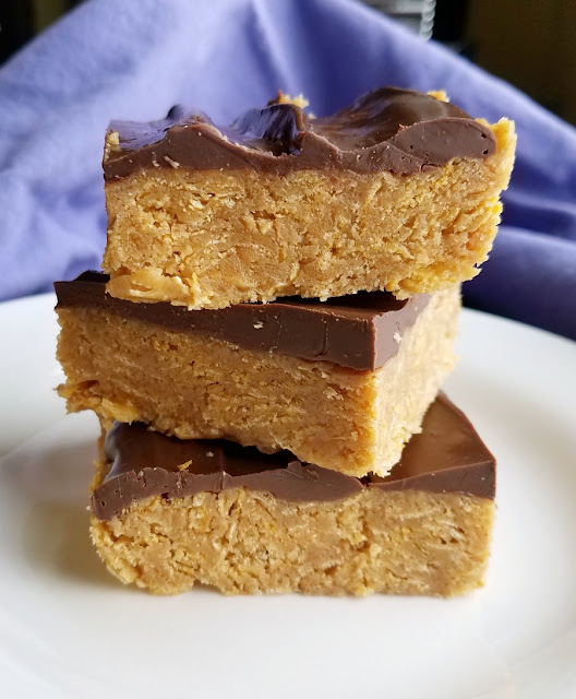 If a quick and easy chocolate peanut butter treat is what you meed, these corn flake bars are just the thing. They are the perfect mix of crunchy, chewy and delicious. stack of peanut butter corn flake squares with chocolate topping