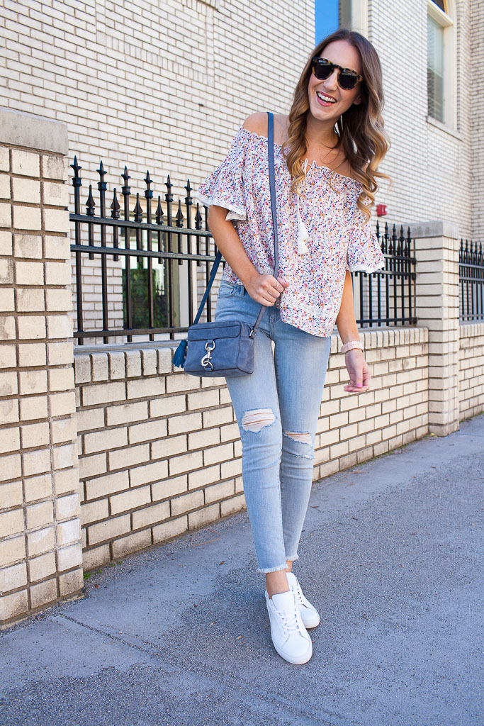 Styling white sneakers for spring with distressed denim and a floral off the shoulder top.