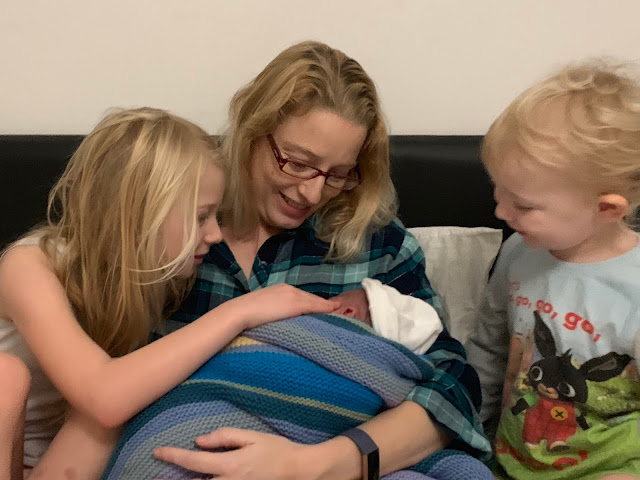 A raw picture of siblings meeting their baby brother for the first time