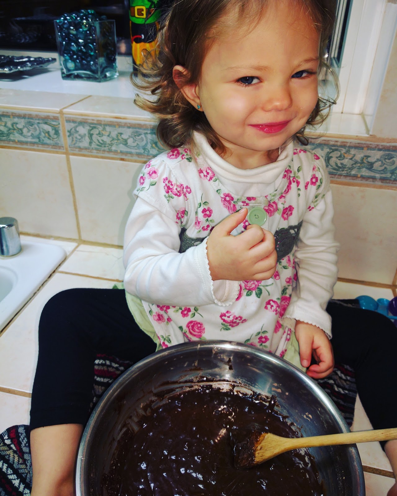 toddler making cakes