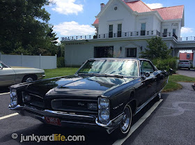 The big black 1966 Pontiac could not be missed with flawless paint and picturesque setting.
