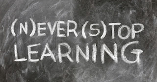 Never stop learning written on a chalkboard