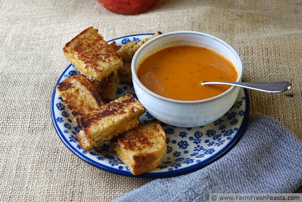 A creamy tomato soup made with home-canned tomatoes, pesto, and roasted garlic.